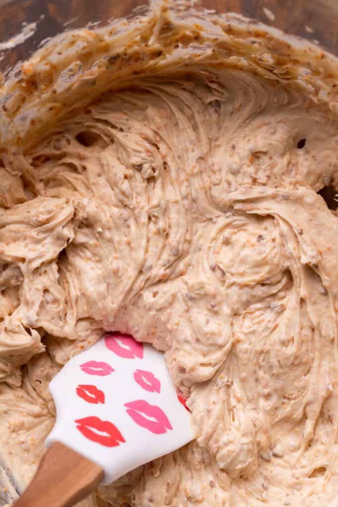 Butterfinger cream cheese frosting in a glass bowl.