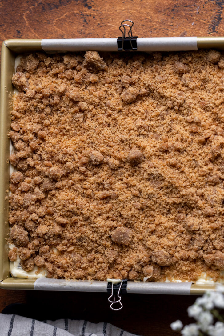 Crumble on top of cheesecake batter.