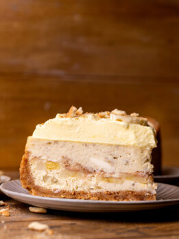 One slice of banana pudding cheesecake on a plate.