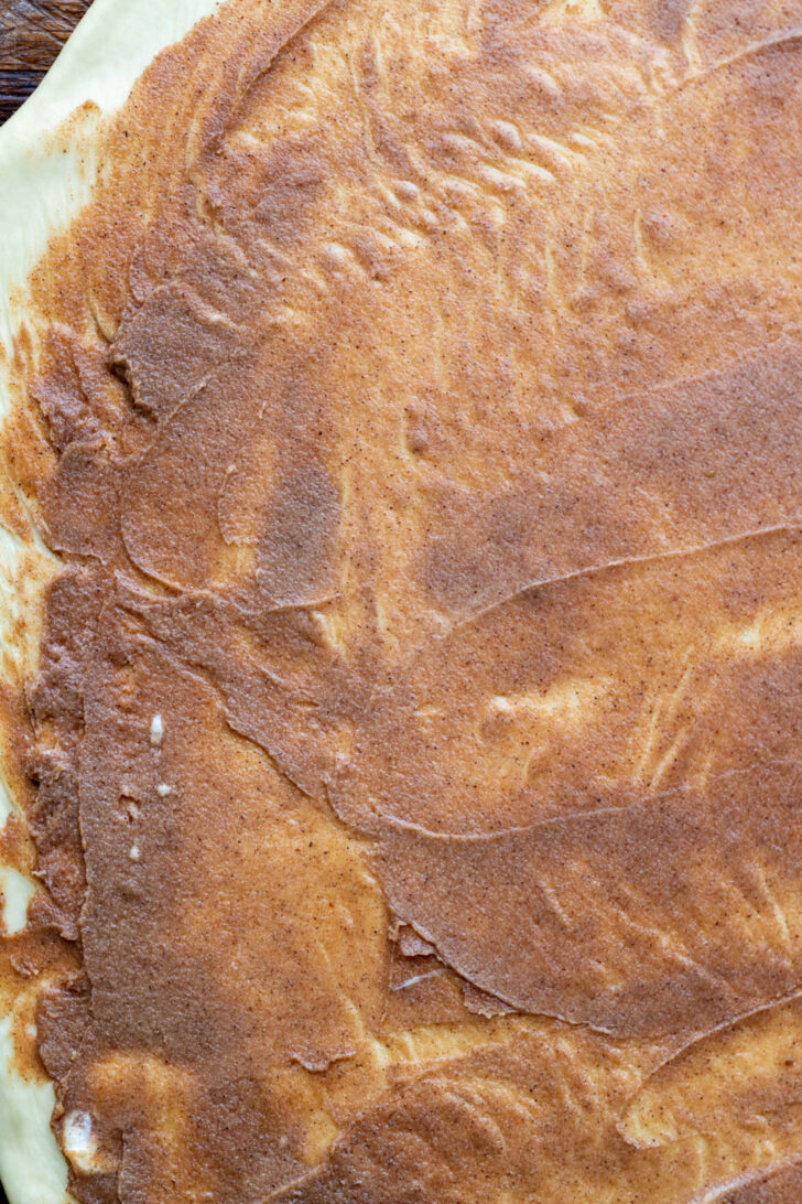 Cinnamon filling on top of the dough.