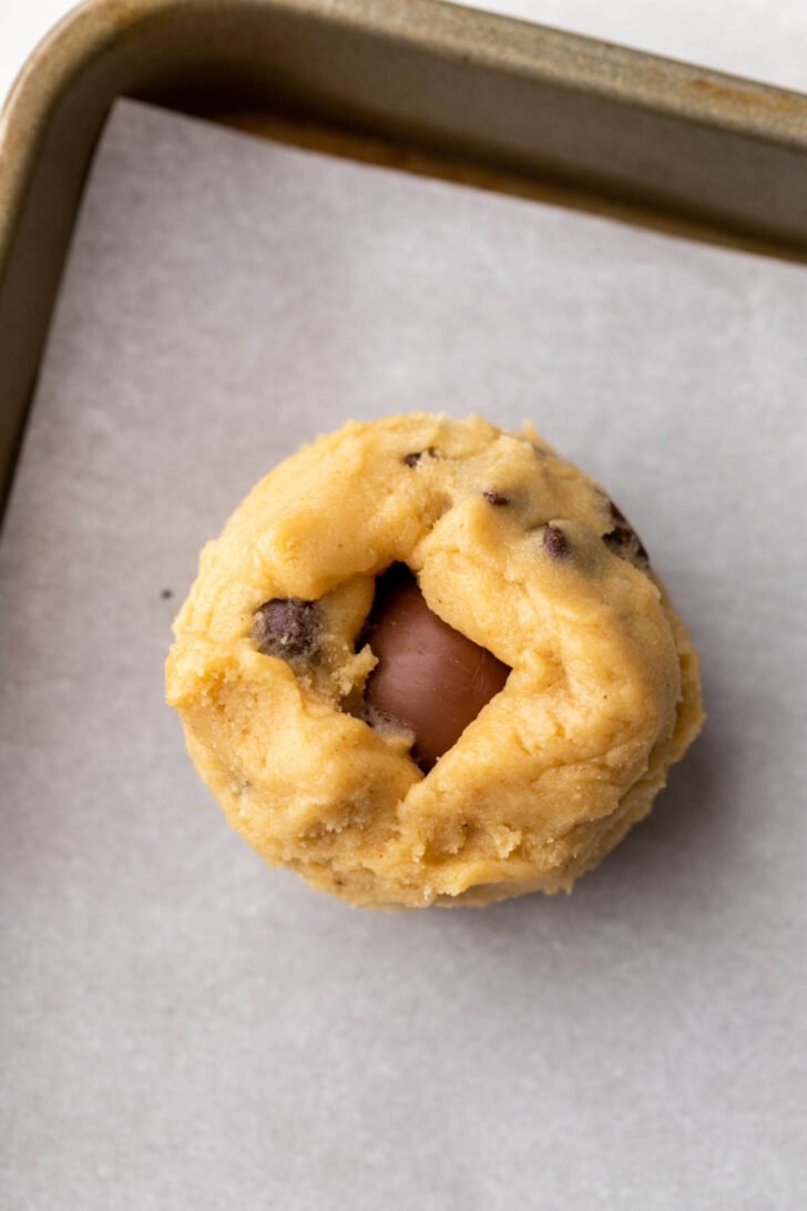 Cookie dough ball on a cookie sheet.