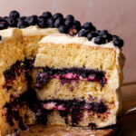 Taking a slice out of the blueberry jam cake.