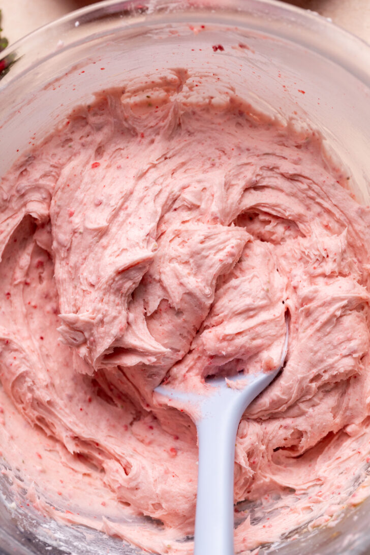 Strawberry cream cheese frosting in a glass bowl.