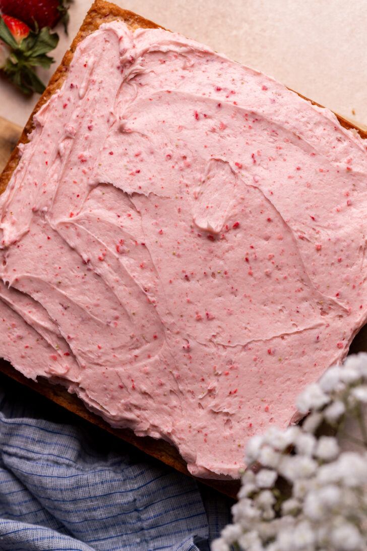 Strawberry frosting on top of cake.