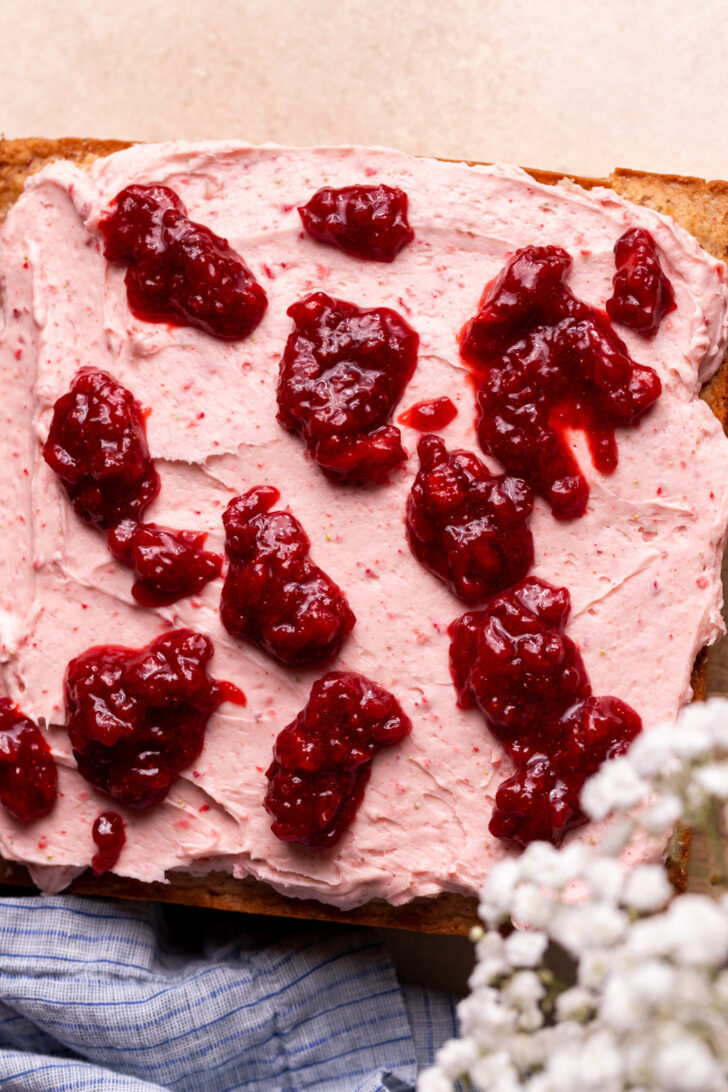 Strawberry jam on top of frosting.