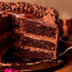 Taking a slice out of the triple chocolate cake.