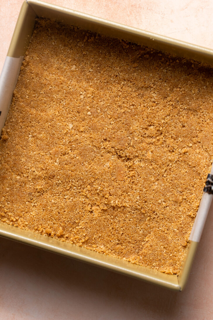 Graham cracker crust in a pan.