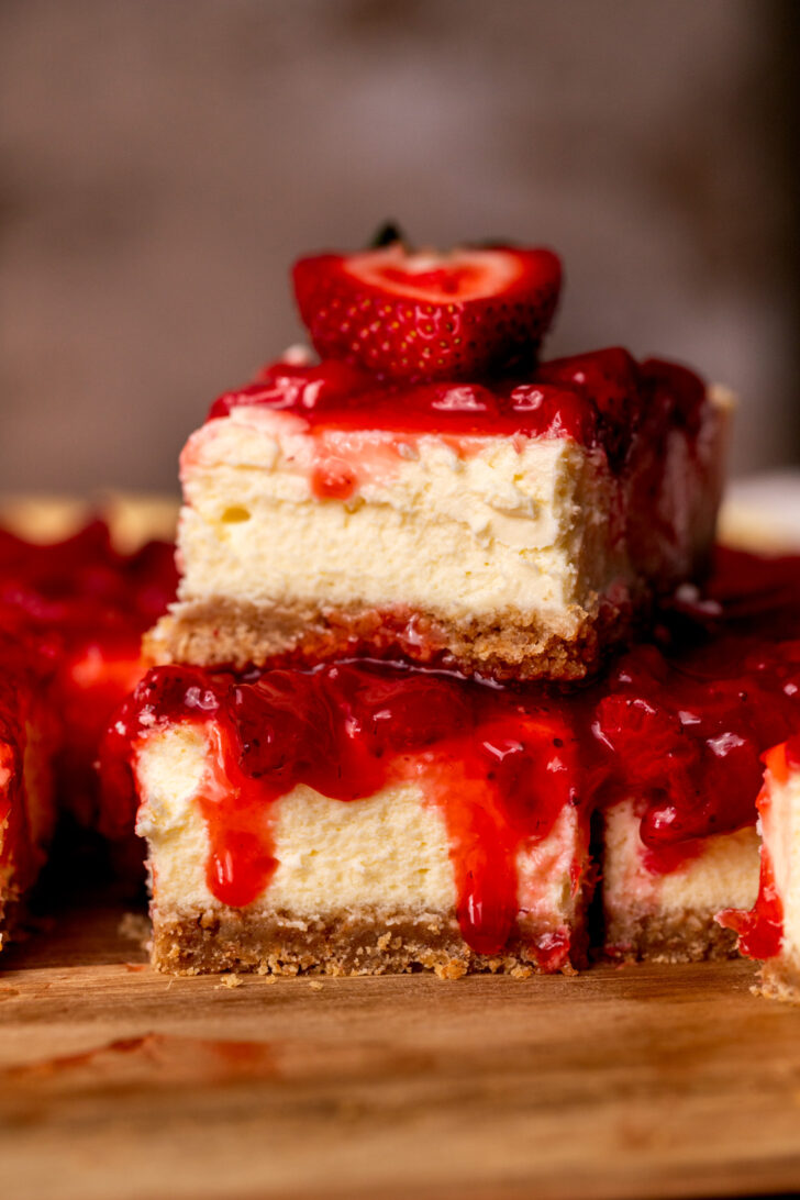 Stack of two strawberry cheesecake bars.