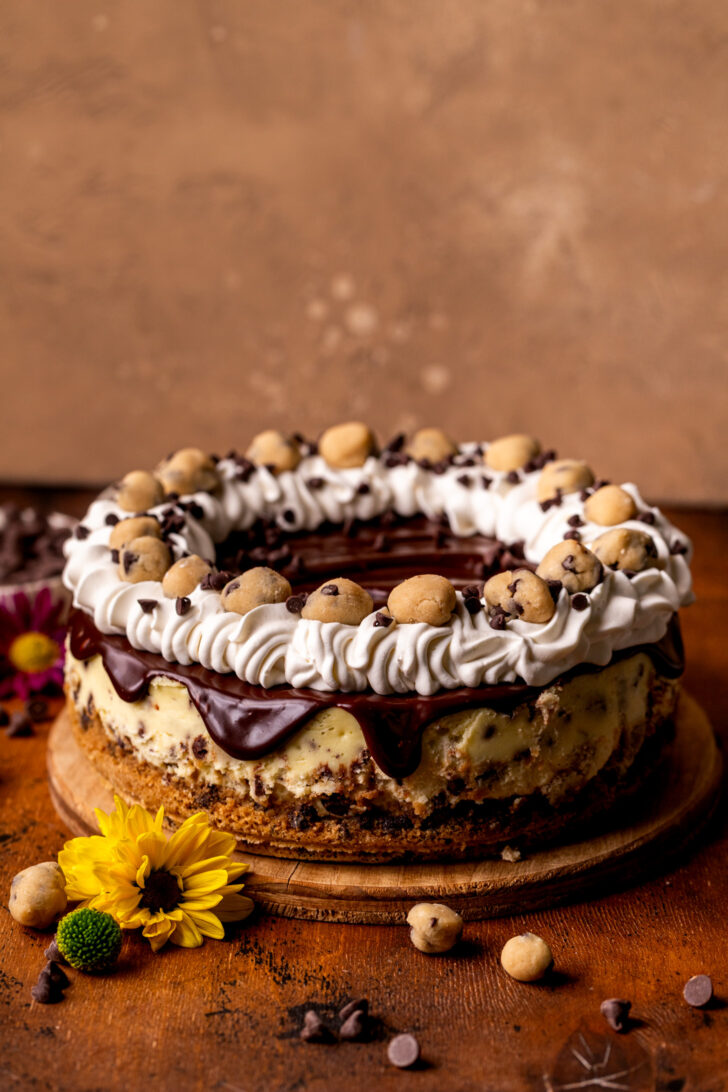 Decorated cheesecake on a wood board.