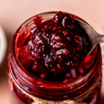 Spoon taking out the raspberry jam.