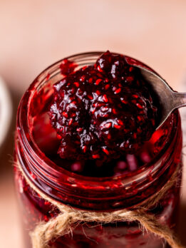Spoon taking out the raspberry jam.