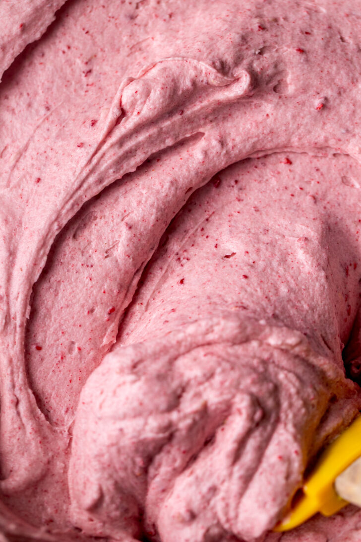 Raspberry frosting in a bowl.
