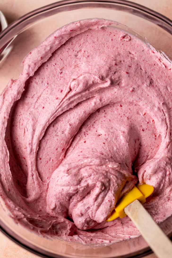 Raspberry frosting in a bowl.