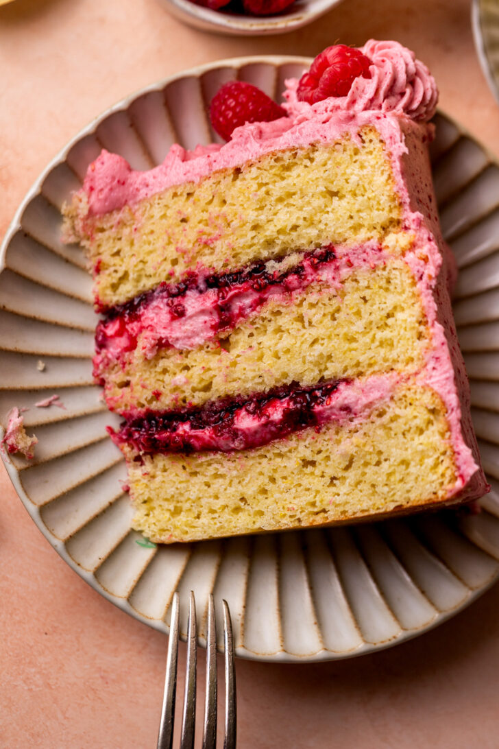 Slice of lemon raspberry cake on a plate.