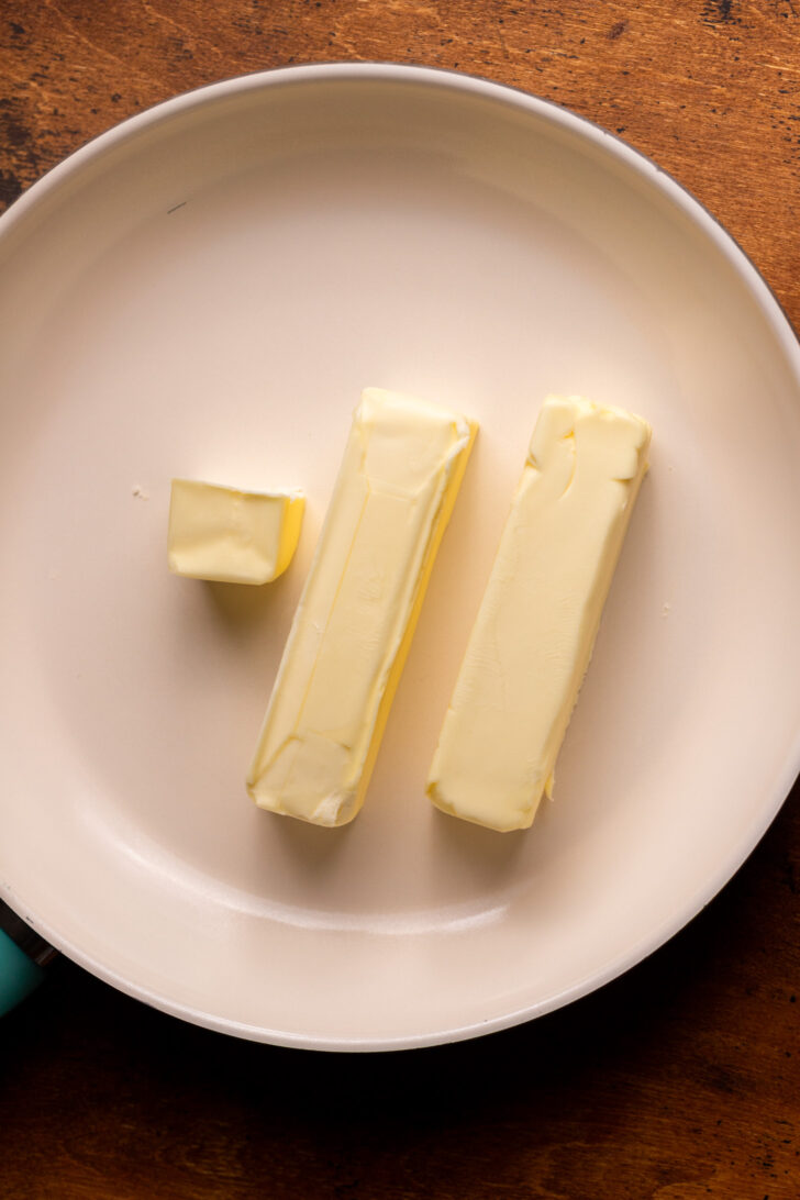 Unmelted butter on a frying pan.