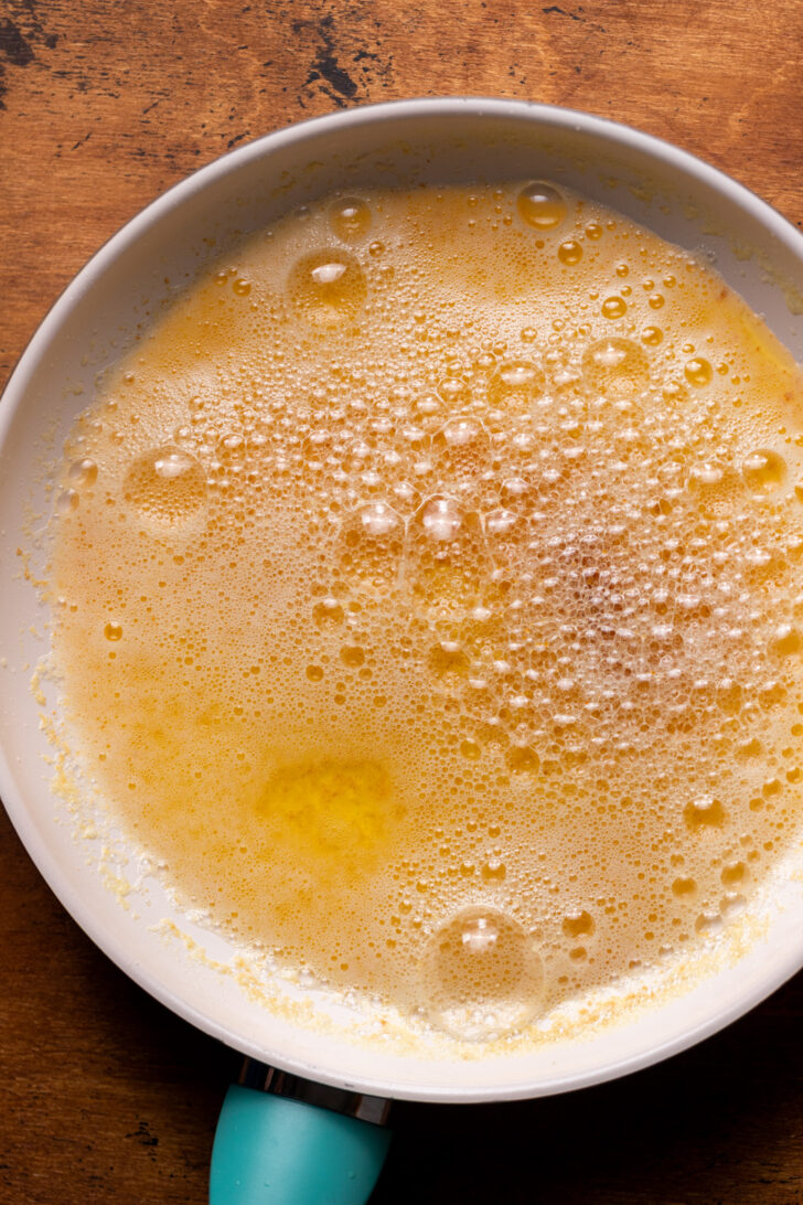 Foamy butter in a frying pan.
