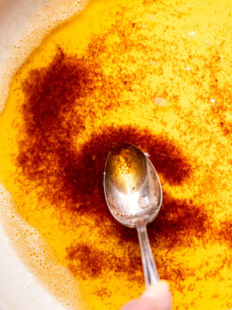 Spoon inserted into brown butter.