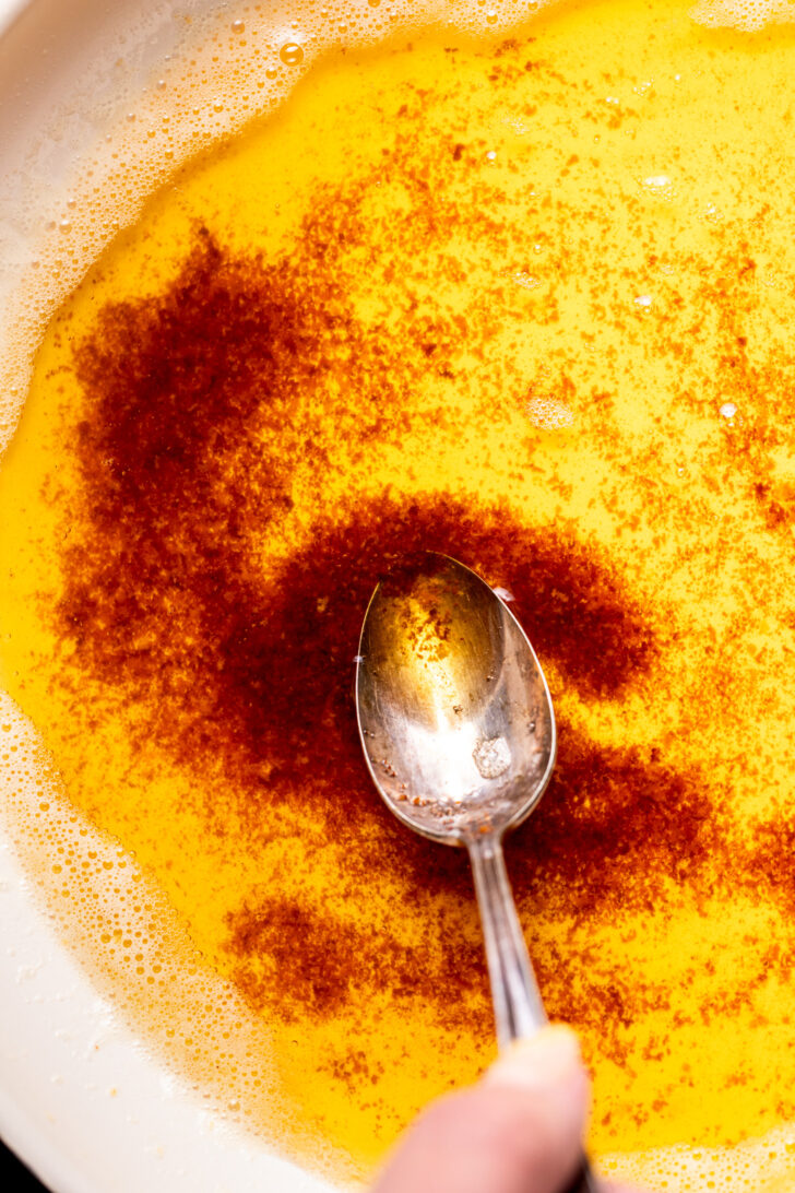 Spoon inserted into brown butter.
