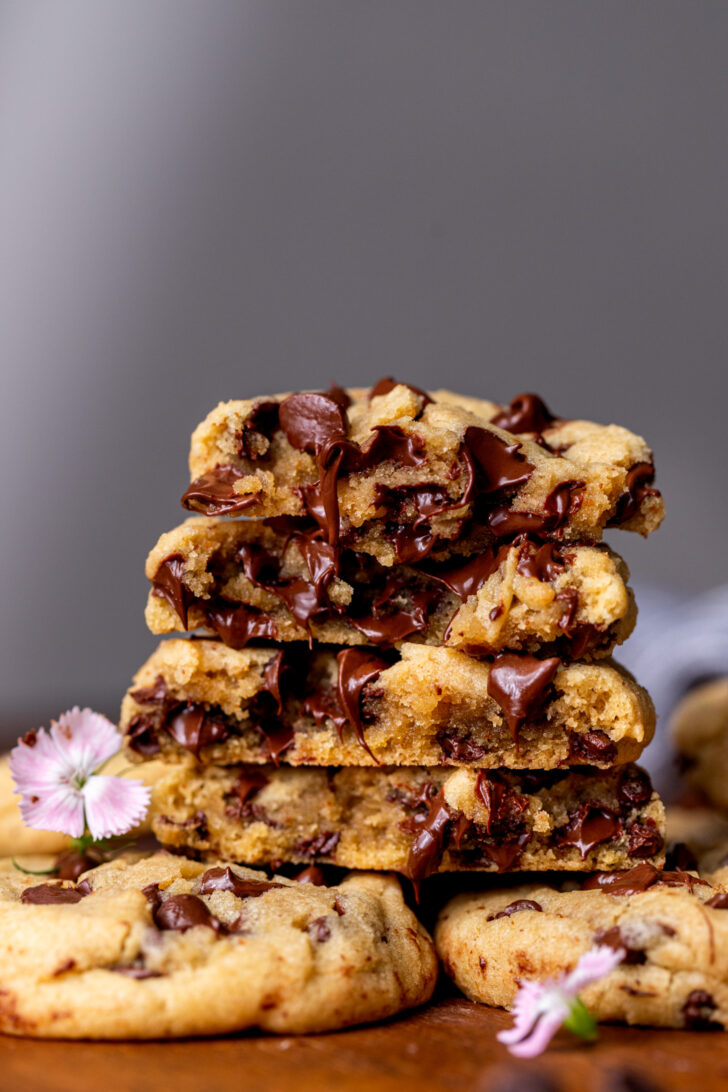 Stack of two brown butter chocolate chip cookies split in half.