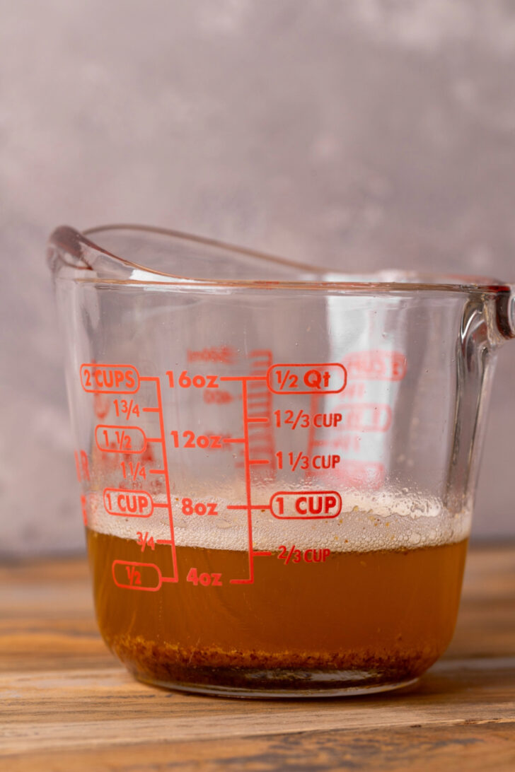 Brown butter in a glass cup.
