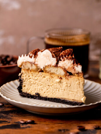 One slice of tiramisu cheesecake on a plate.