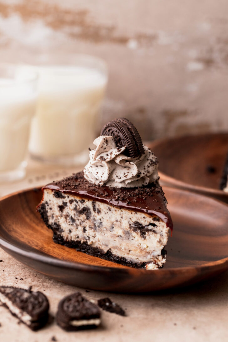 One slice of Oreo cheesecake on a plate.
