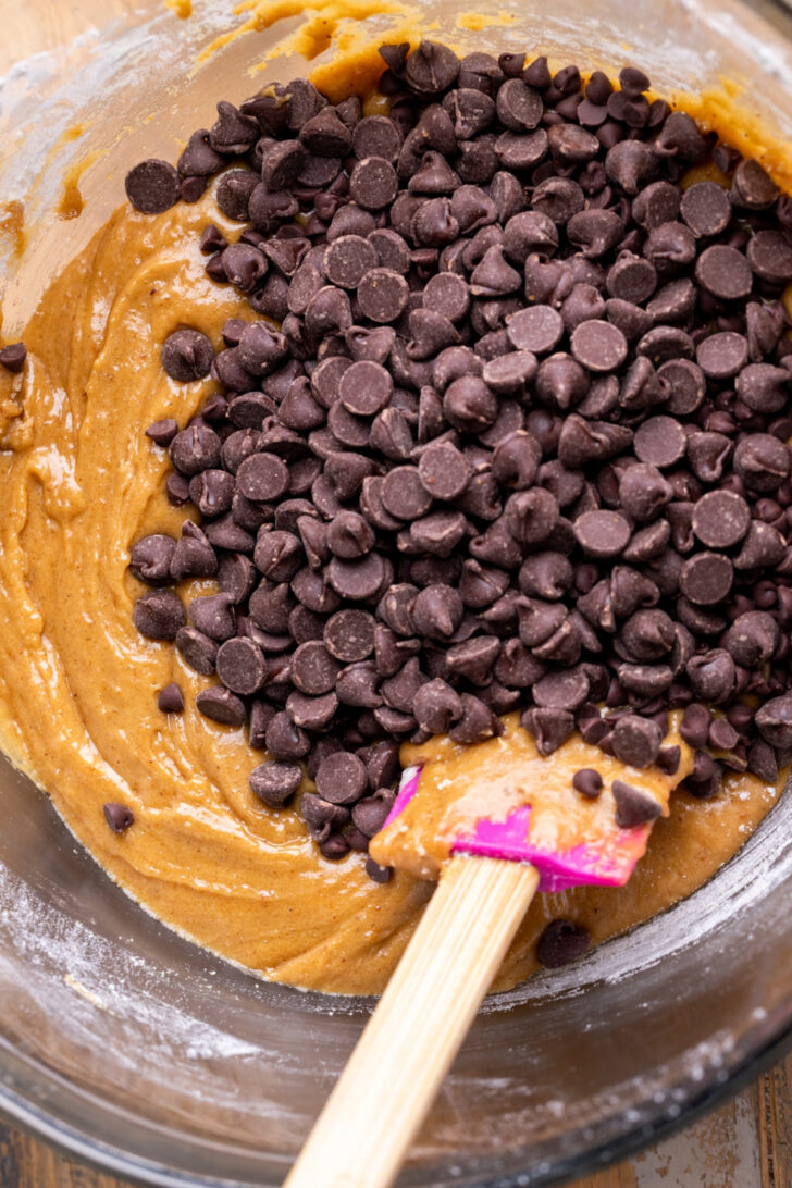 Chocolate chips on top of cookie dough.