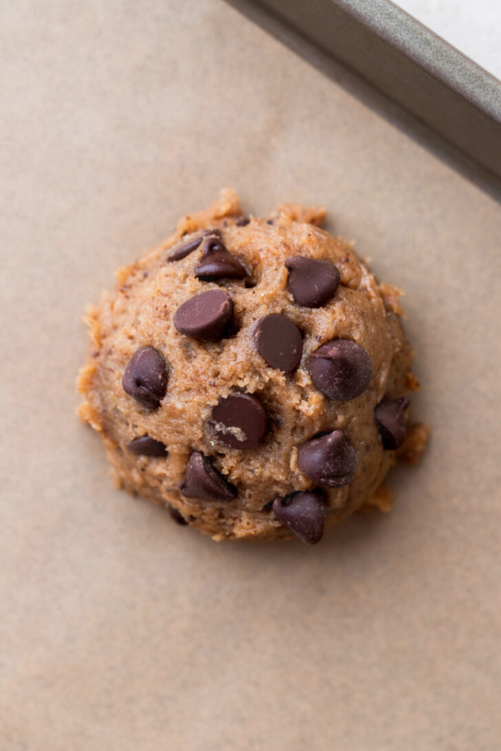 Cookie dough ball on a cookie sheet.