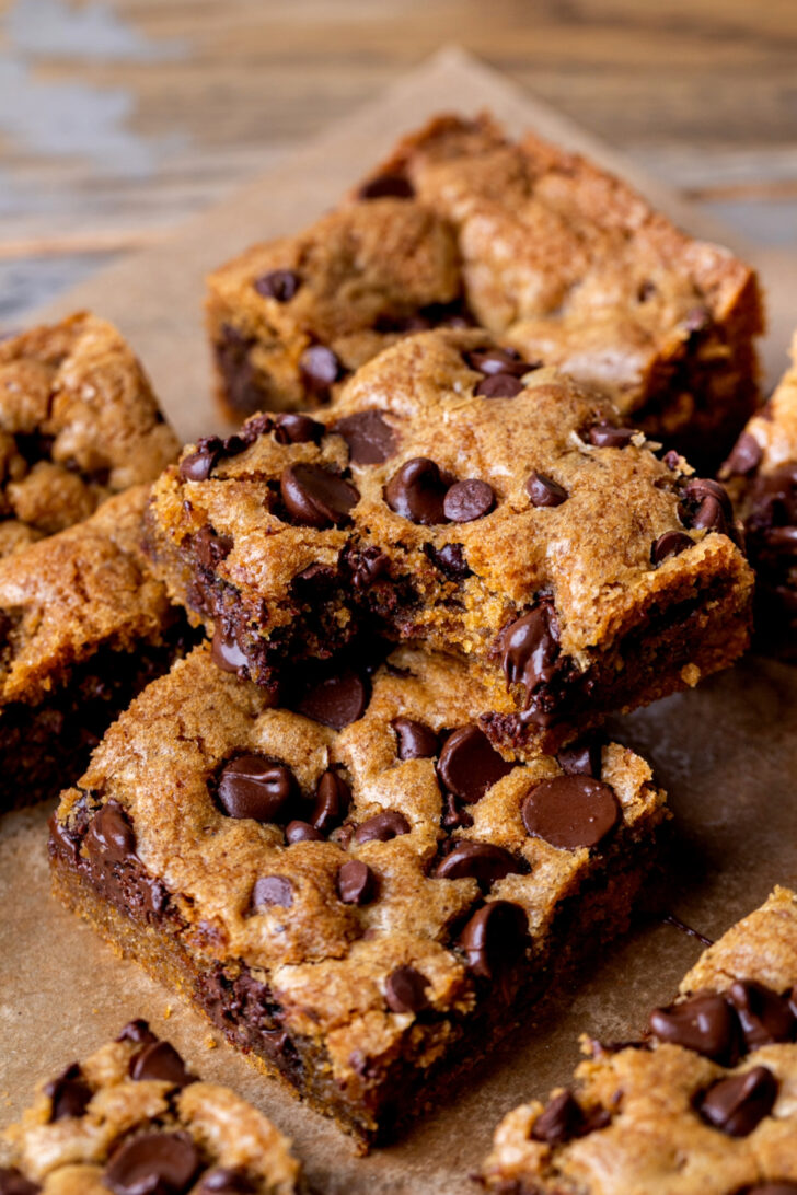 Stack of two brown butter chocolate chip cookie bars with a bite missing.