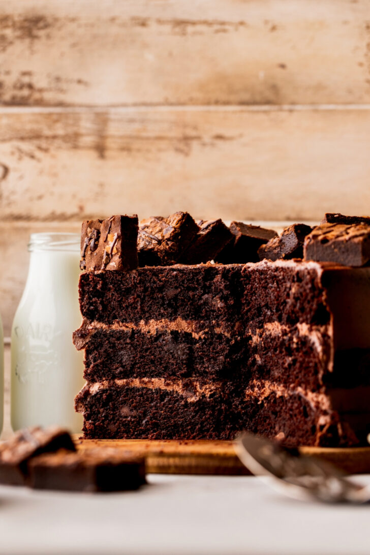 Split in half brownie cake on a board.