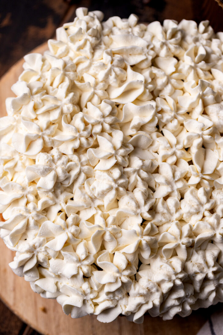 Piped mascarpone on top of the cake.