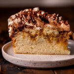 One slice of tiramisu cake on a plate.