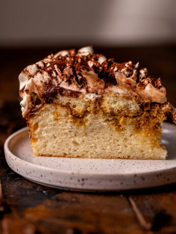 One slice of tiramisu cake on a plate.