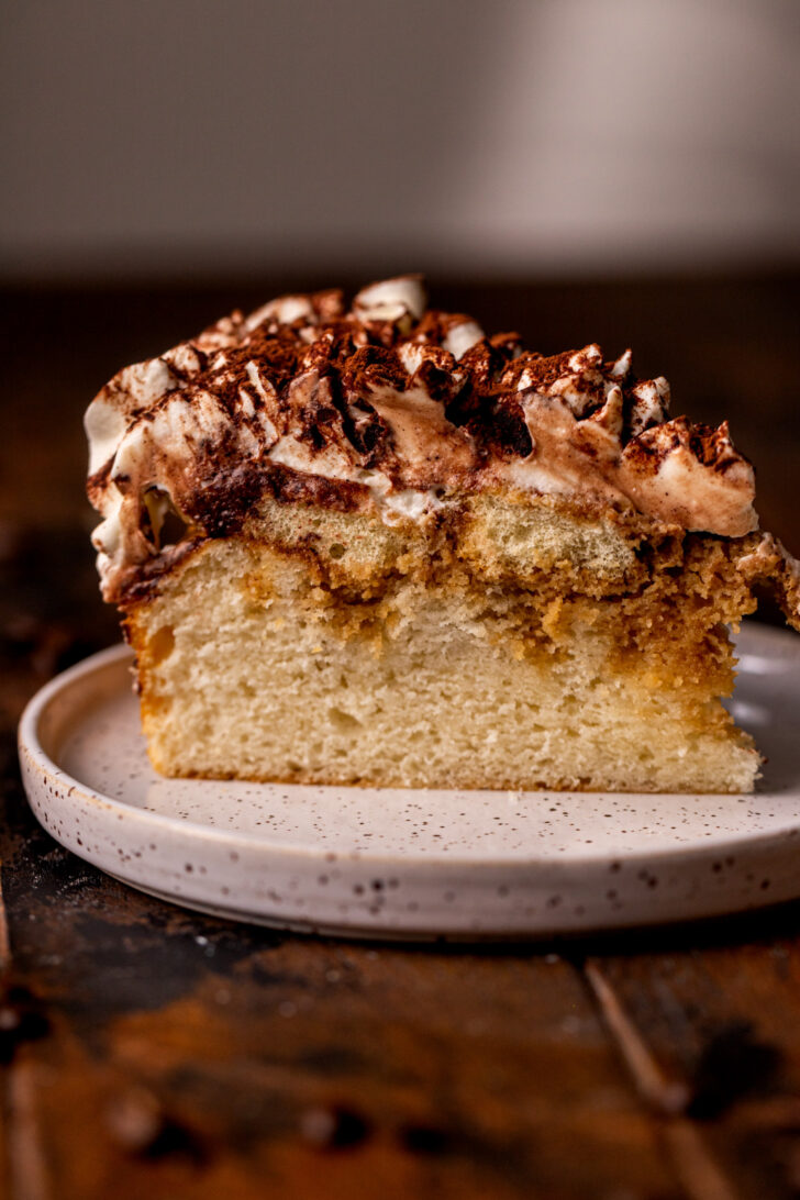 One slice of tiramisu cake on a plate.