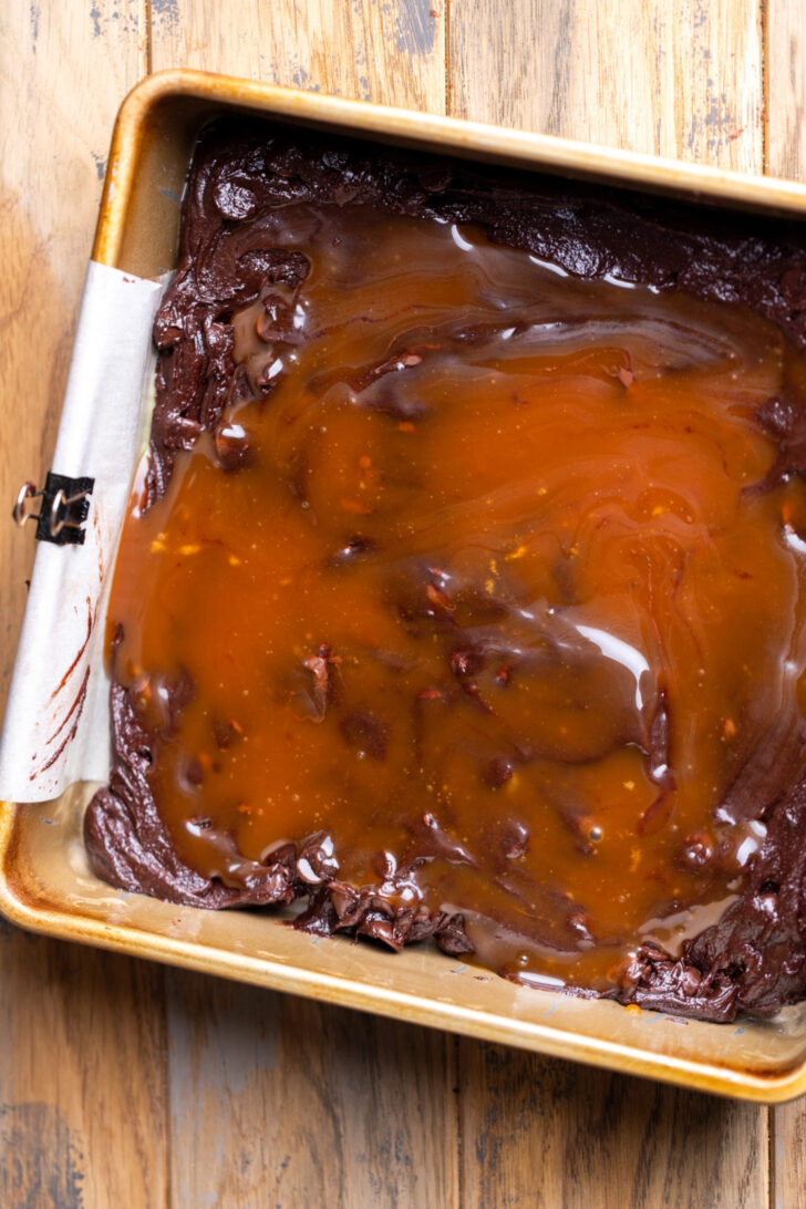 Caramel on top of brownie batter.