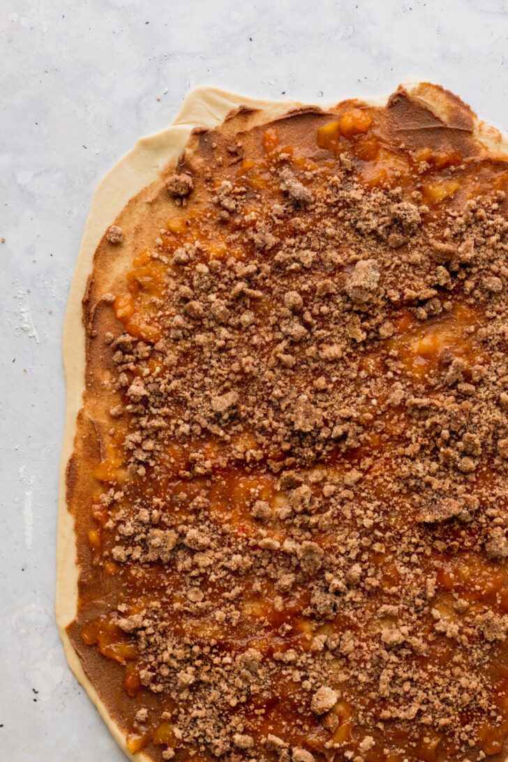 Cinnamon crumble on top of dough.