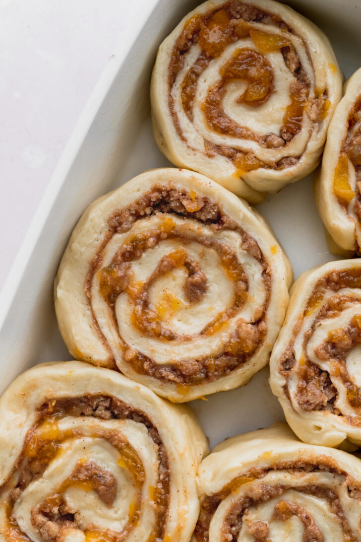 Raw cinnamon rolls in the pan.