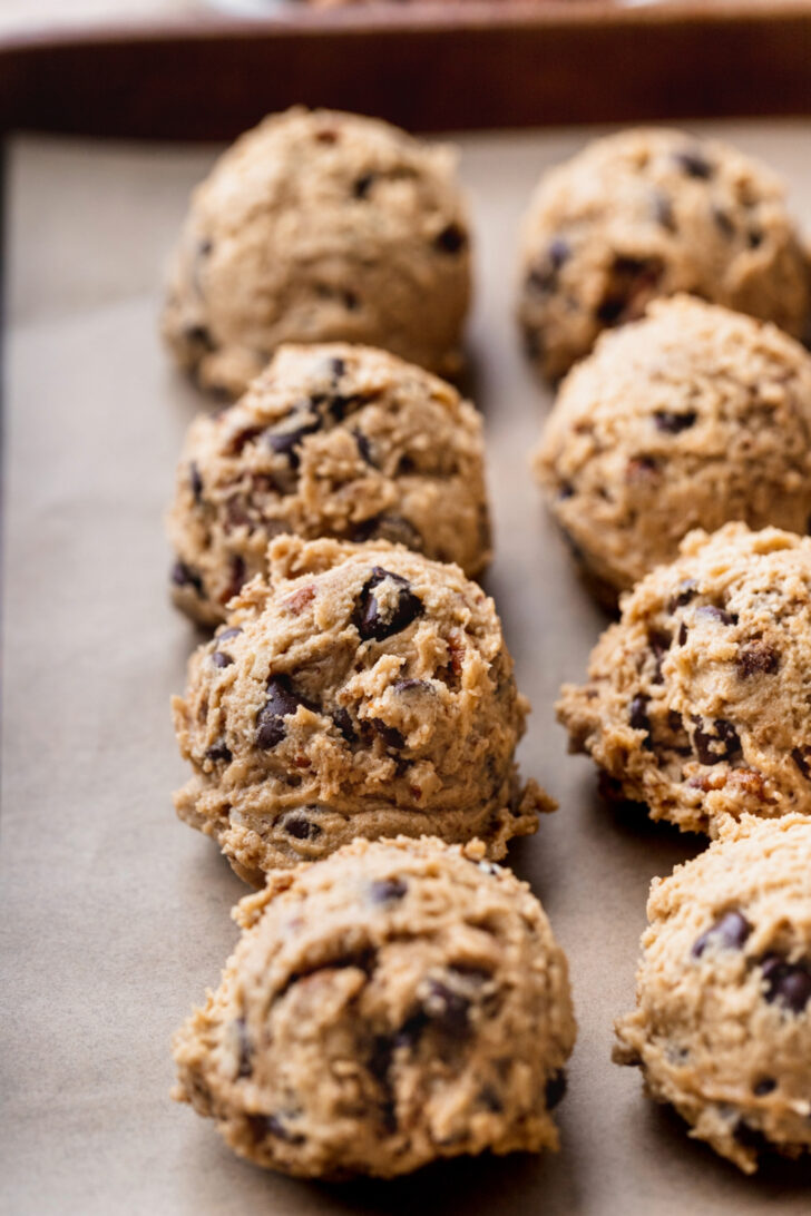 Cookie dough balls on a cookie sheet.