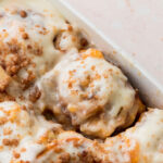 Peach cobbler cinnamon rolls in the pan.