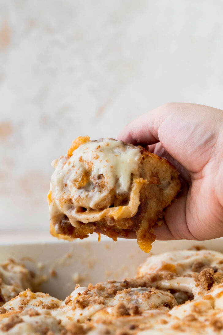 Taking a roll out of the pan.