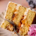 Fork inserted into the peach cobbler cake.