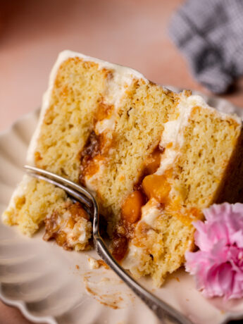 Fork inserted into the peach cobbler cake.