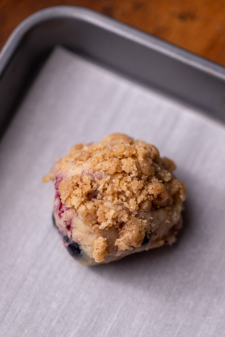Cookie dough ball on cookie sheet.