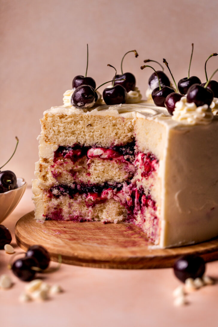 Side view of cake on a wood board.