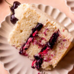 A slice of white forest cake on a plate.