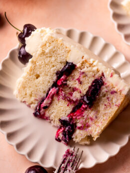 A slice of white forest cake on a plate.