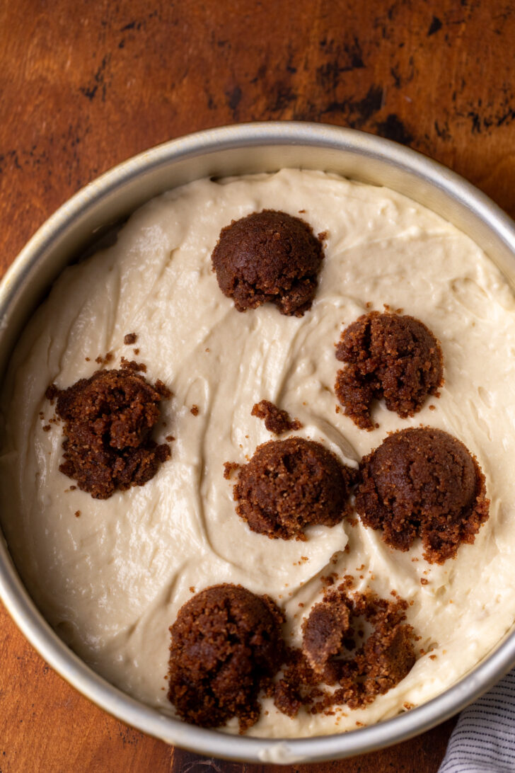 Cake batter with cinnamon dollops in the cake pan.
