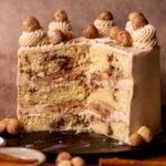 Snickerdoodle cake split open on a wood board.