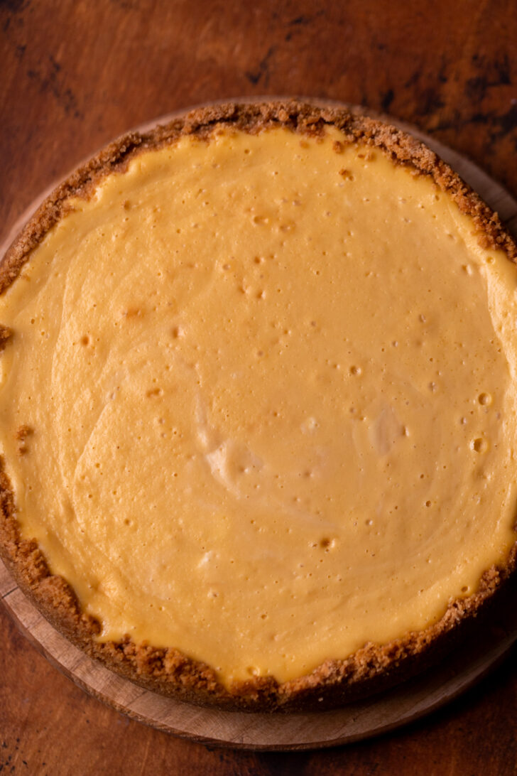 Baked cheesecake on a wood board.