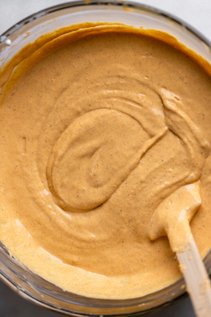 Pumpkin cheesecake batter in a bowl.